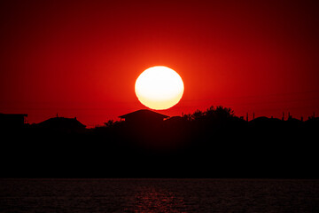 The sun goes down over a lake