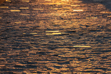 Stone block pavement in the rays of the setting sun. Texture