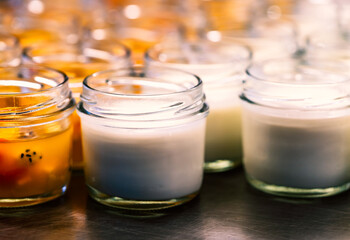 Small bottle glass of Yogurt and fruit salad on stainless steel shelf with, close-up homemade yogurt and fruit salad with warm light.