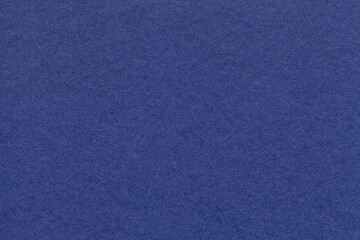 Texture of navy blue and ultramarine colors paper background, macro. Structure of dense craft...