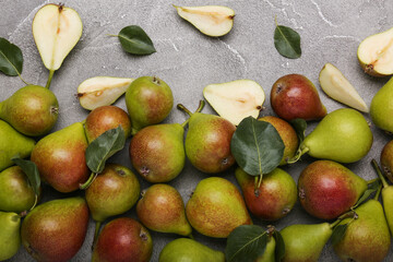 Ripe juicy pears on light cement  table, top view. 