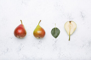 Fresh pears on light background, flat lay composition
