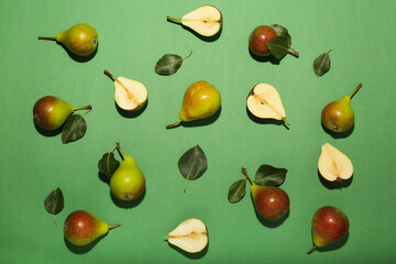 Fresh pears on green background, flat lay composition, top view space