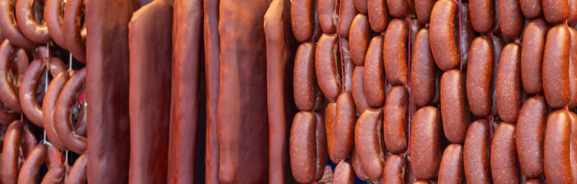 Turkish food bacon (pastirma) hanging on luxury delicatessen counter. traditional appetizer of the month of ramadan.