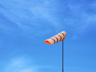 Wind direction bag and cloud in the blue sky is background.