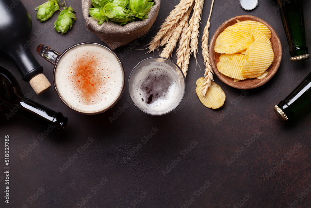 Wall mural lager beer mug, bottles, hops and wheat on old stone table