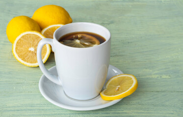 Black coffee, lemon slices, in white ceramic cup.