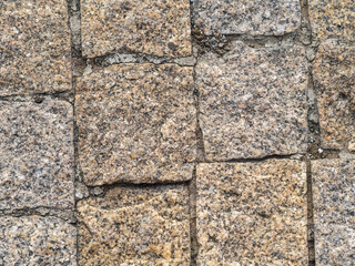 Stone block pavement in the rays of the setting sun. Texture