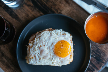 Toast with cheese and sausage covered with fried egg