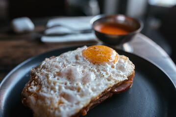 Toast with cheese and sausage covered with fried egg