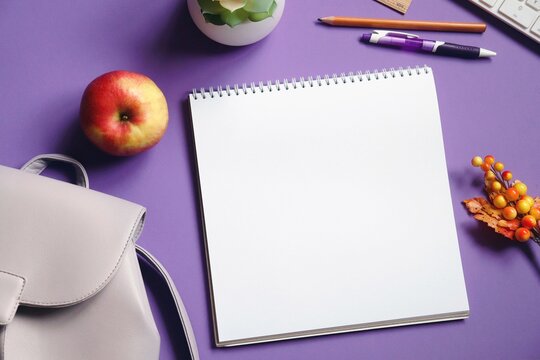 Back to school flat lay photo. Paper notebook, pen, pencil, backpack and apple on a purple table. Mockup, free space for text