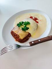 Fresh lasagna with cream sauce served on a plate