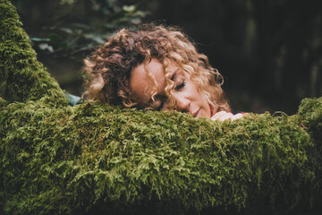 People enjoy and love feeling with green nature. Serene woman have relax and rest with face on a...
