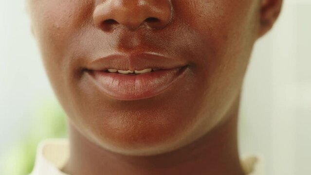 Native African American woman portrait. Female person smiling. Close-up of toothy smile, mouth, happy face. Pretty latin model. 
