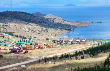 Baikal Lake. Top view of Small Sea Strait and popular summer vacation spot on shore of warm Kurkut Bay and tourist wooden hotels houses