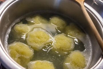 a pot full of dumplings in the water
