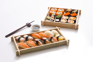 sushi set and sushi roll on wooden board