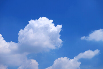 Fluffy Cumulus Clouds Floating on Vivid Blue Sunny Sky