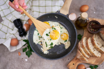 Fried Egg in cast iron frying pan on black induction hob