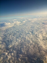 high above white fluffy clouds blue sky