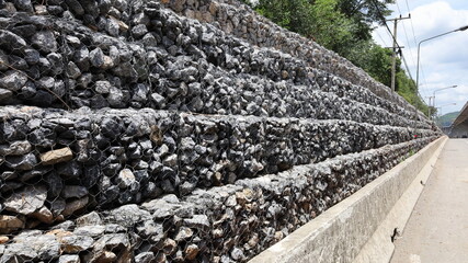 Stonewall to prevent landslides. The roadside gabion stone walls protect against mountain...