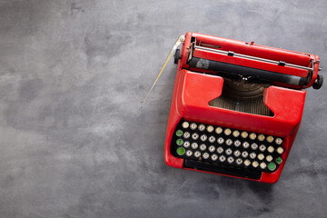 Journalism or blogging concept - vintage typewriter on the grey desk, top view