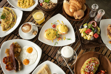 Obraz na płótnie Canvas many mixed western breakfast food items on cafe table