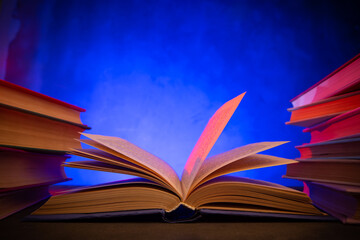 Wisdom and education concept.Book on the table, love reading. Retro neon light 90s