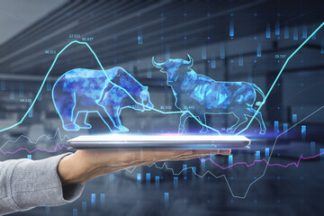 bulls and bears struggle. Equity market illustration. Close up of hand holding tablet with creative...