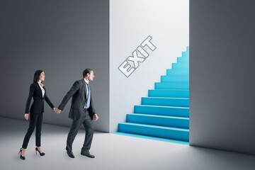 Thoughtful young businesswoman and man in concrete interior looking at blue stairs exit. Way out, teamwork, solution and choice concept.