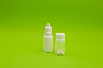 Empty jars, tubes, bottles on a green background