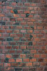 Old brick wall with red bricks close up.