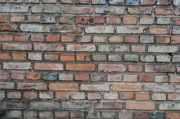 Old brick wall with red bricks close up.