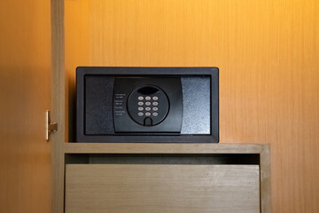 a gray safe in the wardrobe. It's a small safe that can hold valuables while you're out to travel.