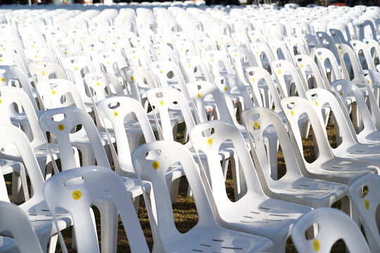 Many White Plastic Chairs Were Set Up In A Square Area With The Row And Column For Outdoor Concerts Or Open Air Events.