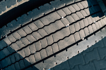 Close up of semi-truck tyres on sunny wheel, cars mechanic 