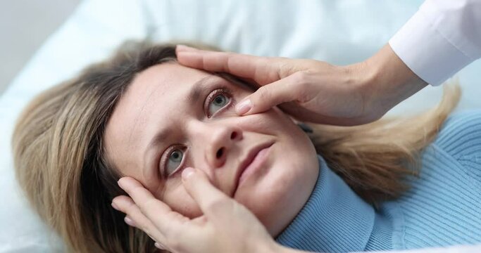 Doctor examining eyes of sick female patient in clinic 4k movie slow motion