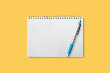 Notebook blank with pen isolated on yellow background included clipping path.