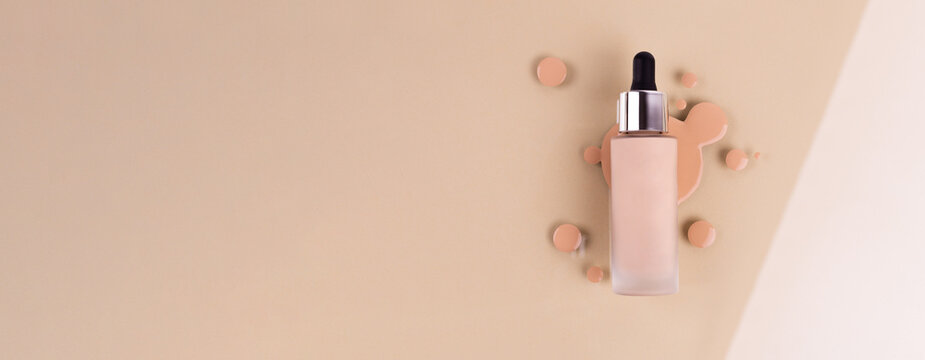 Spilled liquid foundation. Mockup glass bottle of correction cosmetic product with pipette and brush for make up on red background. beauty branding concept. Banner