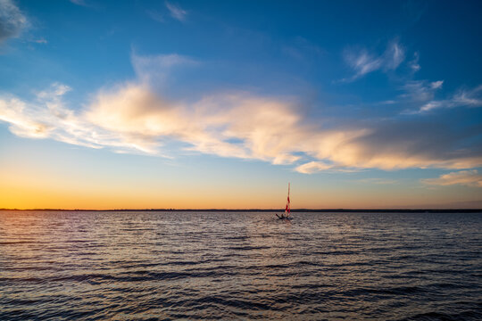 sunset over the sea with sailboat