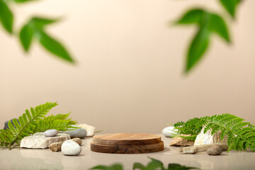 Background for cosmetic products of natural beige color. Wood podium with green leaves and natural stones - obrazy, fototapety, plakaty