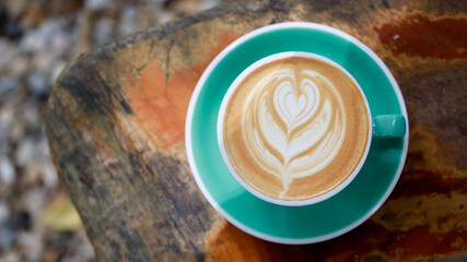 Green cup of coffee,Beautiful cappuccino in a glass on the table, favorite cup of coffee concept in the morning.