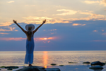 Woman enjoying freedom at sunset