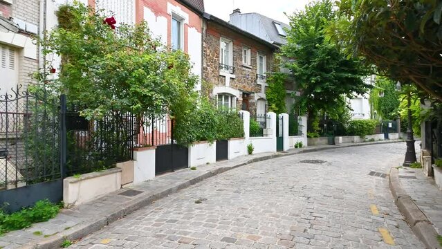 Paris, France.June 2022. Paris to discover: the quiet and pretty neighborhood called the countryside in Paris. A place that makes you think you are in a fairy tale with small brick houses. Pan footage