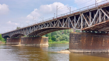 old metal rust train bridge over the Vistula river in Warsaw 