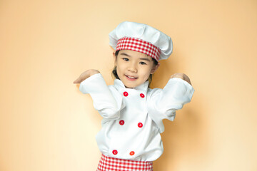 Smiling Asian girl wearing chef uniform