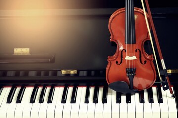 Classical violin placed vertically on the piano. leave space for text