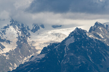 Beautiful snow covered mountains with in the fog and dramatic clouds.