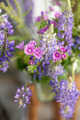 Beautiful bouquet of wild flowers. Lupin and malva flowers in blossom
