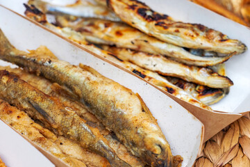 Crispy fried fish with a mixture of flour and spices, fried with hot oil, street food. Smelt fish